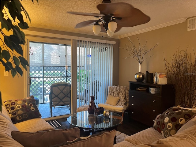 2500 Winding Creek Blvd Unit B105, Clearwater, FL 33761 - living area featuring a ceiling fan, ornamental molding, and a textured ceiling
