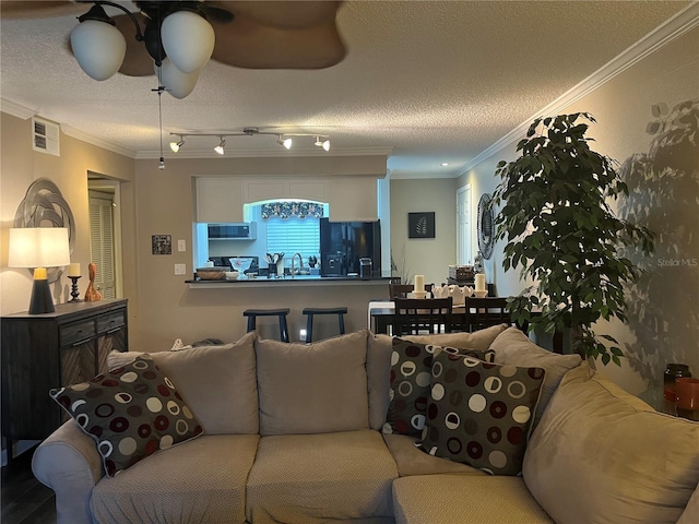 2500 Winding Creek Blvd Unit B105, Clearwater, FL 33761 - living area with a textured ceiling, ornamental molding, and a ceiling fan