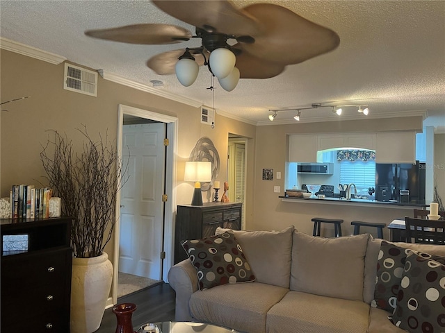 2500 Winding Creek Blvd Unit B105, Clearwater, FL 33761 - living area featuring a textured ceiling, crown molding, and a ceiling fan
