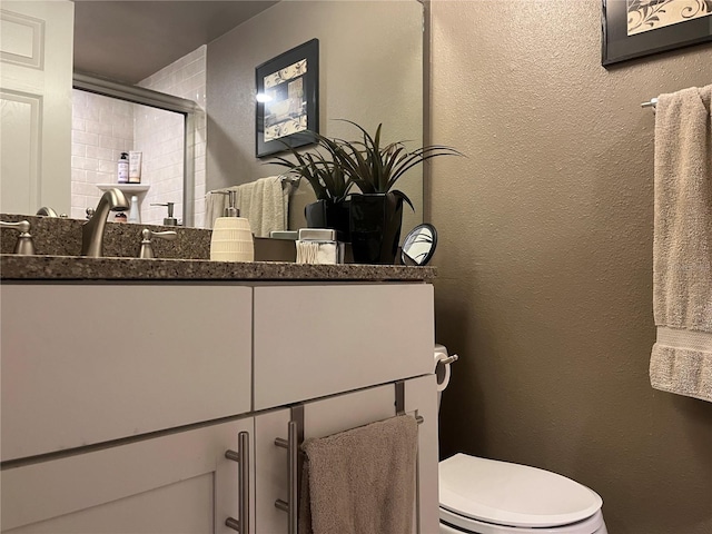 2500 Winding Creek Blvd Unit B105, Clearwater, FL 33761 - bathroom featuring vanity, a textured wall, and an enclosed shower