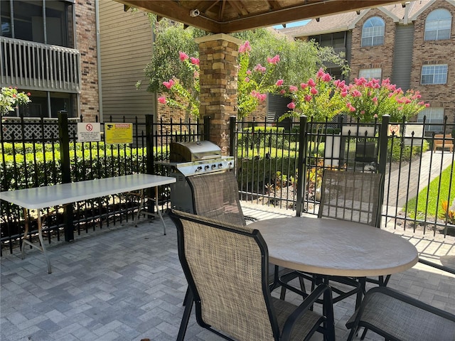 2500 Winding Creek Blvd Unit B105, Clearwater, FL 33761 - view of patio with outdoor dining space and area for grilling