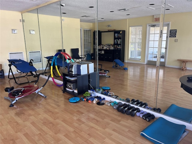 2500 Winding Creek Blvd Unit B105, Clearwater, FL 33761 - workout area featuring wood finished floors and a textured ceiling
