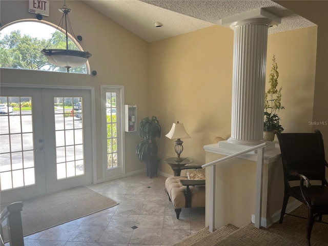 2500 Winding Creek Blvd Unit B105, Clearwater, FL 33761 - entrance foyer with ornate columns, plenty of natural light, french doors, a textured ceiling, and lofted ceiling