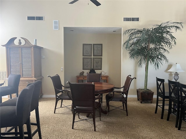 2500 Winding Creek Blvd Unit B105, Clearwater, FL 33761 - dining room with carpet floors, a ceiling fan, and a towering ceiling
