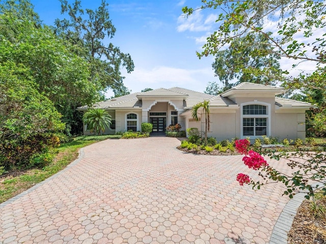713 Argyle Pl, Temple Terrace, FL 33617 - mediterranean / spanish home featuring french doors, decorative driveway, stucco siding, a garage, and a tiled roof