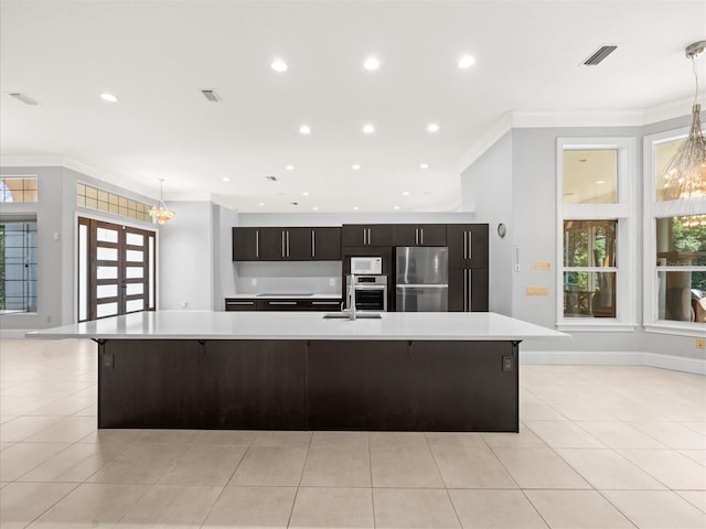 713 Argyle Pl, Temple Terrace, FL 33617 - kitchen with stainless steel appliances, light countertops, crown molding, a large island, and light tile patterned flooring