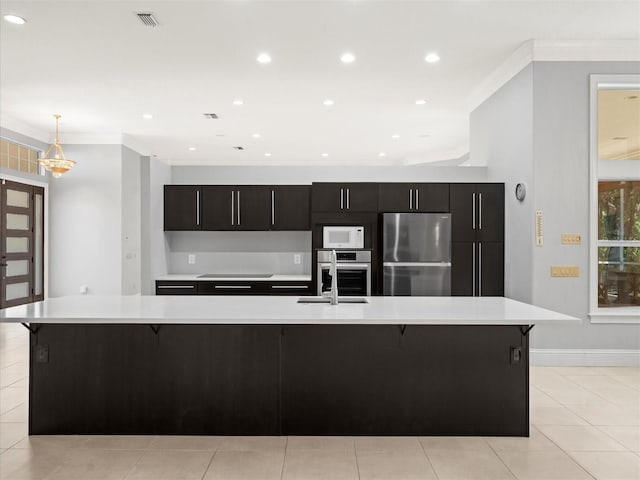 713 Argyle Pl, Temple Terrace, FL 33617 - kitchen featuring appliances with stainless steel finishes, light countertops, a breakfast bar area, a large island, and ornamental molding