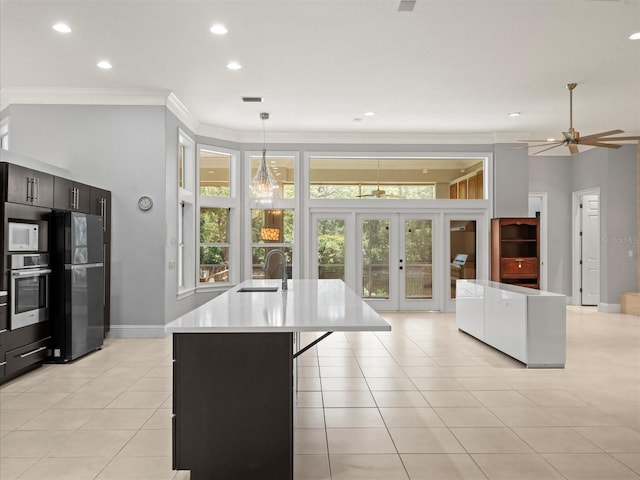 713 Argyle Pl, Temple Terrace, FL 33617 - kitchen with stainless steel oven, freestanding refrigerator, french doors, white microwave, and plenty of natural light