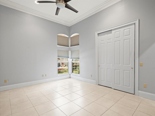 713 Argyle Pl, Temple Terrace, FL 33617 - unfurnished bedroom featuring ornamental molding, light tile patterned flooring, a closet, and ceiling fan