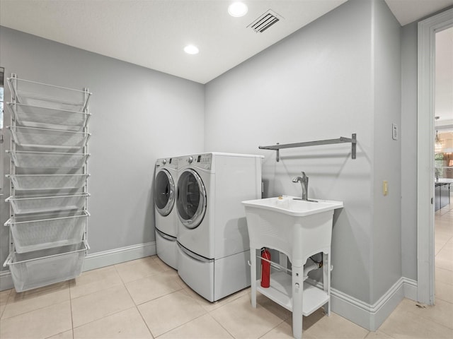 713 Argyle Pl, Temple Terrace, FL 33617 - laundry area with washer and dryer, light tile patterned flooring, and recessed lighting