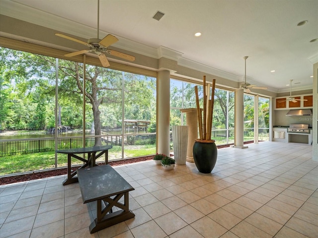 713 Argyle Pl, Temple Terrace, FL 33617 - unfurnished sunroom featuring view of scattered trees, a water view, and healthy amount of natural light