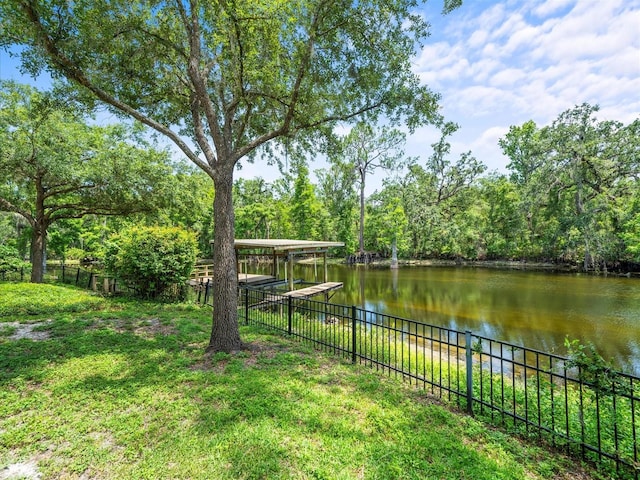 713 Argyle Pl, Temple Terrace, FL 33617 - view of yard with a water view, a boat dock, and a carport
