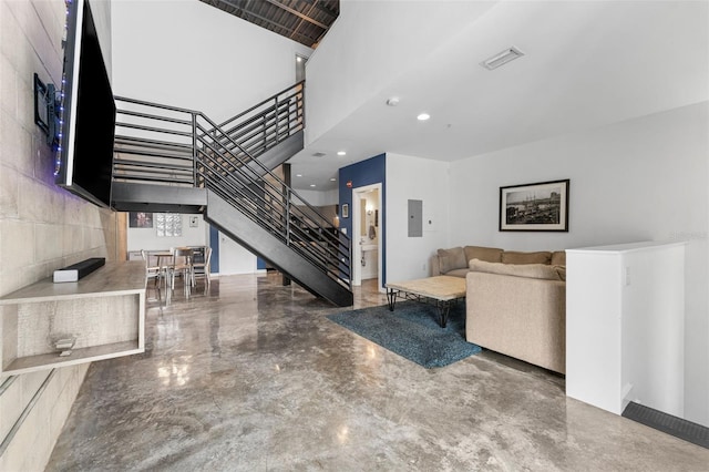 5008 S Macdill Ave Unit 16, Tampa, FL 33611 - unfurnished living room with stairway, electric panel, a high ceiling, finished concrete flooring, and recessed lighting