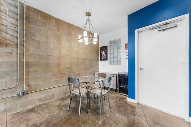 5008 S Macdill Ave Unit 16, Tampa, FL 33611 - dining space featuring concrete flooring, a chandelier, and wine cooler