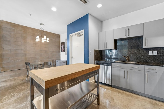 5008 S Macdill Ave Unit 16, Tampa, FL 33611 - kitchen with stainless steel dishwasher, gray cabinets, concrete flooring, a chandelier, and decorative light fixtures