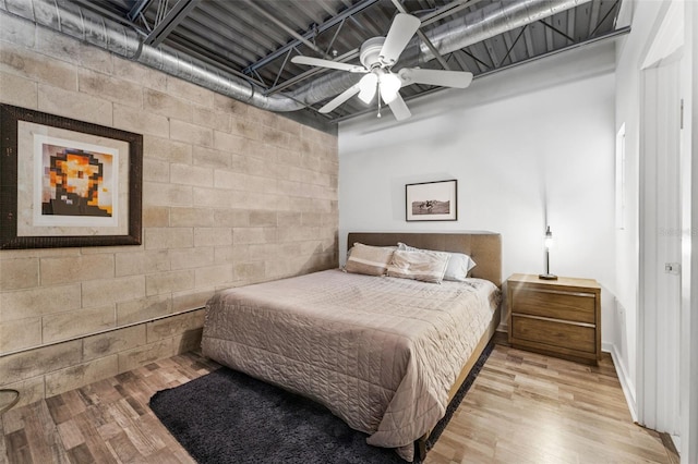 5008 S Macdill Ave Unit 16, Tampa, FL 33611 - bedroom featuring light wood-style floors, concrete block wall, and ceiling fan