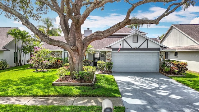 1906 White Cedar Way, Brandon, FL 33511 - view of front facade with driveway, a garage, stone siding, and a front lawn