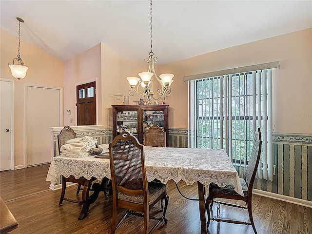 1906 White Cedar Way, Brandon, FL 33511 - dining area with lofted ceiling, a chandelier, wood finished floors, and wainscoting