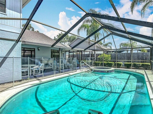 1906 White Cedar Way, Brandon, FL 33511 - view of swimming pool featuring glass enclosure, a patio area, and a pool with connected hot tub