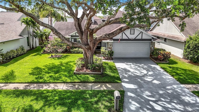1906 White Cedar Way, Brandon, FL 33511 - tudor house featuring a garage, driveway, a front yard, a shingled roof, and a residential view