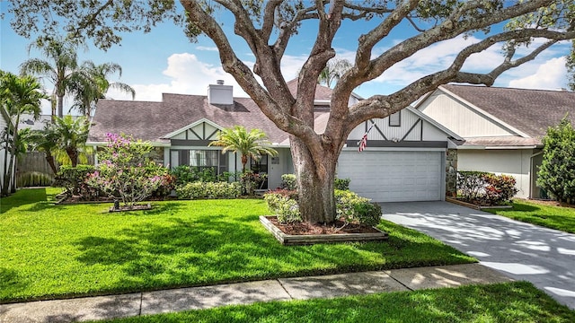 1906 White Cedar Way, Brandon, FL 33511 - tudor house with a garage, a front lawn, concrete driveway, a chimney, and roof with shingles
