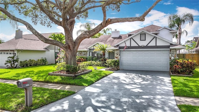 1906 White Cedar Way, Brandon, FL 33511 - view of front of home featuring a garage, driveway, stone siding, and a chimney