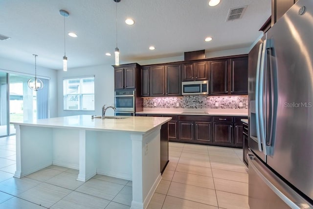 11035 Sage Canyon Dr, Riverview, FL 33578 - kitchen with stainless steel appliances, decorative backsplash, light countertops, recessed lighting, and light tile patterned floors