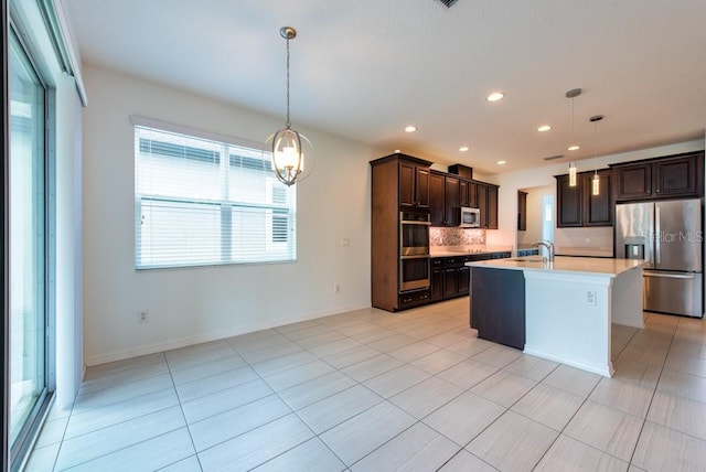 11035 Sage Canyon Dr, Riverview, FL 33578 - kitchen with stainless steel appliances, light countertops, dark brown cabinetry, tasteful backsplash, and recessed lighting