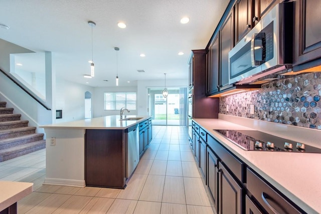 11035 Sage Canyon Dr, Riverview, FL 33578 - kitchen featuring stainless steel appliances, tasteful backsplash, light countertops, recessed lighting, and dark brown cabinets