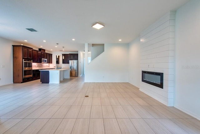 11035 Sage Canyon Dr, Riverview, FL 33578 - unfurnished living room with a fireplace and recessed lighting