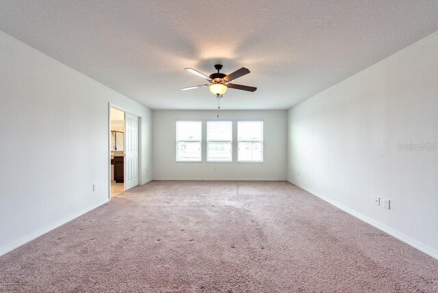 11035 Sage Canyon Dr, Riverview, FL 33578 - unfurnished room featuring light colored carpet, a ceiling fan, and a textured ceiling