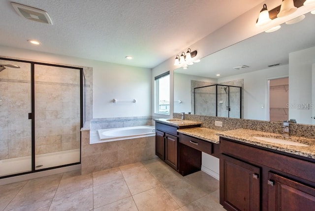11035 Sage Canyon Dr, Riverview, FL 33578 - bathroom featuring double vanity, a shower stall, a garden tub, a spacious closet, and tile patterned floors