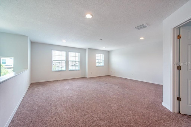 11035 Sage Canyon Dr, Riverview, FL 33578 - empty room featuring light colored carpet, recessed lighting, and a textured ceiling