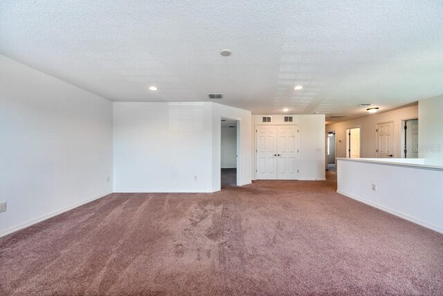11035 Sage Canyon Dr, Riverview, FL 33578 - unfurnished living room featuring carpet floors, recessed lighting, and a textured ceiling