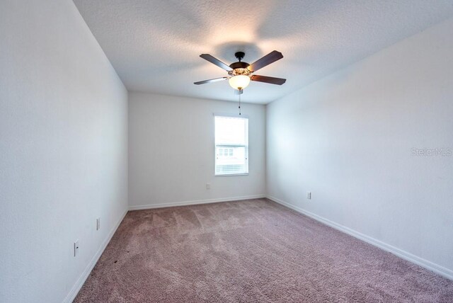 11035 Sage Canyon Dr, Riverview, FL 33578 - unfurnished room featuring light carpet, ceiling fan, and a textured ceiling