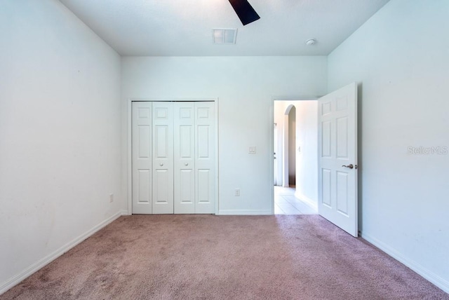 11035 Sage Canyon Dr, Riverview, FL 33578 - unfurnished bedroom with carpet flooring, arched walkways, a closet, and ceiling fan