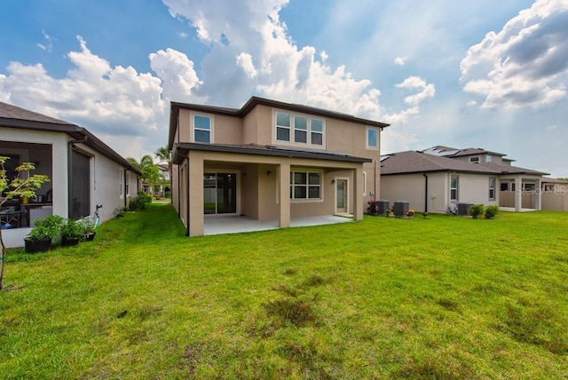 11035 Sage Canyon Dr, Riverview, FL 33578 - back of property with stucco siding, a patio, and a lawn