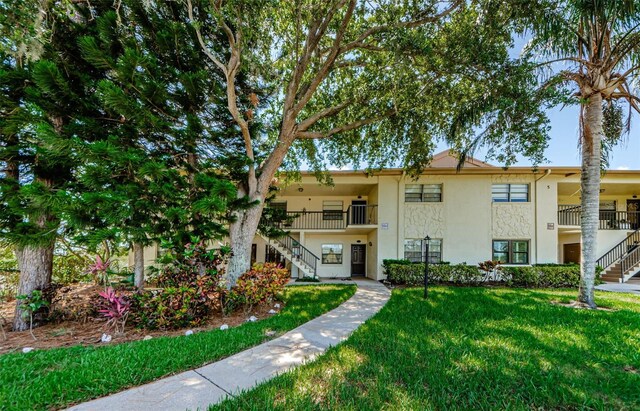 1729 Seascape Cir Unit 102, Tarpon Springs, FL 34689 - view of building exterior featuring stairway