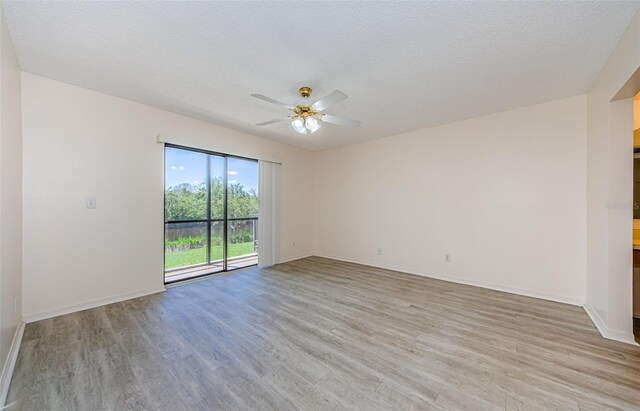 1729 Seascape Cir Unit 102, Tarpon Springs, FL 34689 - spare room with light wood finished floors, a ceiling fan, and a textured ceiling