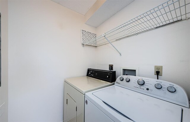 1729 Seascape Cir Unit 102, Tarpon Springs, FL 34689 - laundry area with washing machine and clothes dryer