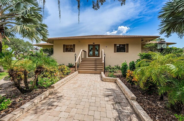 1729 Seascape Cir Unit 102, Tarpon Springs, FL 34689 - bungalow-style home with french doors and stucco siding