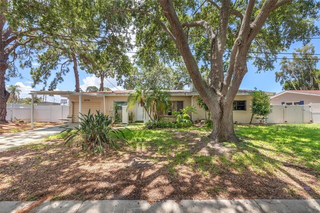 10730 52nd Ave N, Saint Petersburg, FL 33708 - ranch-style house with a gate, an attached carport, stucco siding, and concrete driveway