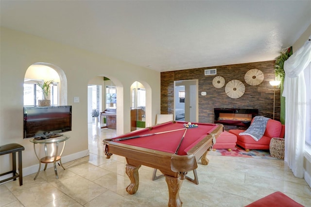 10730 52nd Ave N, Saint Petersburg, FL 33708 - recreation room with an accent wall, a glass covered fireplace, and billiards