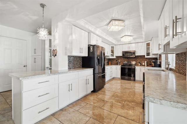 10730 52nd Ave N, Saint Petersburg, FL 33708 - kitchen featuring appliances with stainless steel finishes, a chandelier, decorative backsplash, white cabinets, and glass insert cabinets