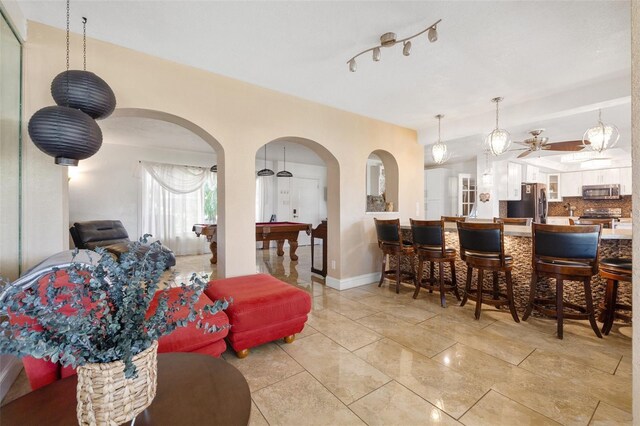 10730 52nd Ave N, Saint Petersburg, FL 33708 - living room featuring arched walkways and ceiling fan