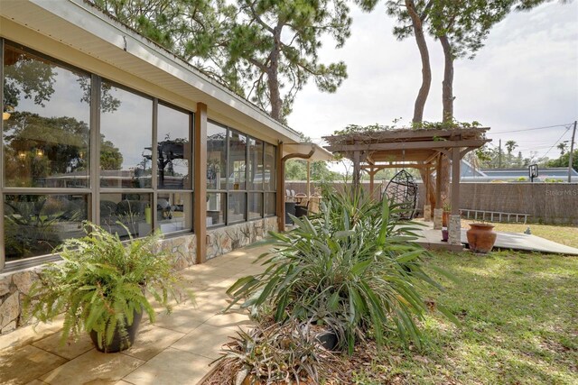 10730 52nd Ave N, Saint Petersburg, FL 33708 - fenced backyard with a sunroom and a patio