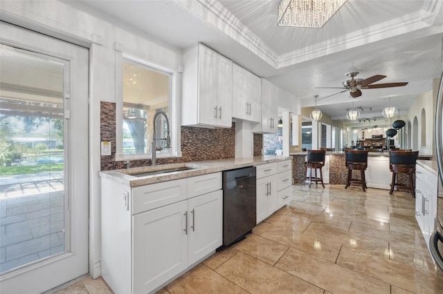 10730 52nd Ave N, Saint Petersburg, FL 33708 - kitchen with dishwashing machine, decorative backsplash, white cabinetry, and a ceiling fan