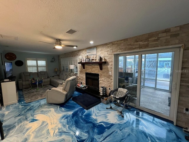 6531 Seaview Blvd, Hudson, FL 34667 - living room with a textured ceiling, a ceiling fan, and a stone fireplace