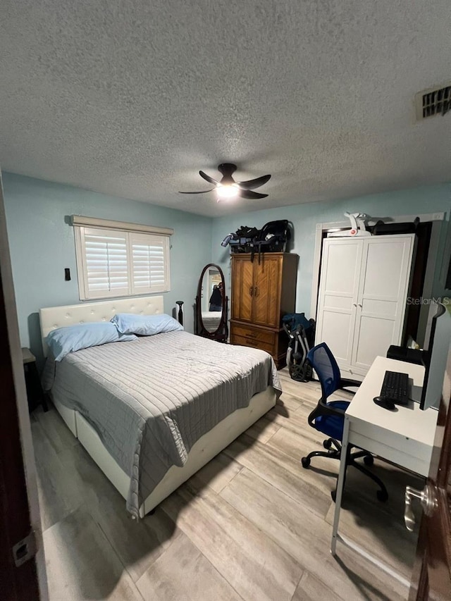 6531 Seaview Blvd, Hudson, FL 34667 - bedroom featuring light wood-style floors, an office area, a ceiling fan, and a textured ceiling