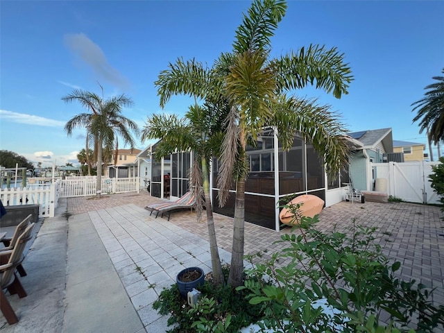 6531 Seaview Blvd, Hudson, FL 34667 - fenced backyard with a gate, a patio area, and a sunroom